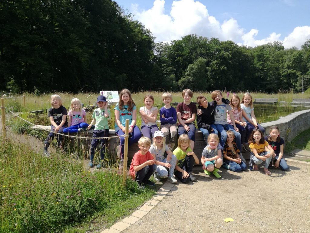 20 Kinder im Gruppenfoto in der Natur